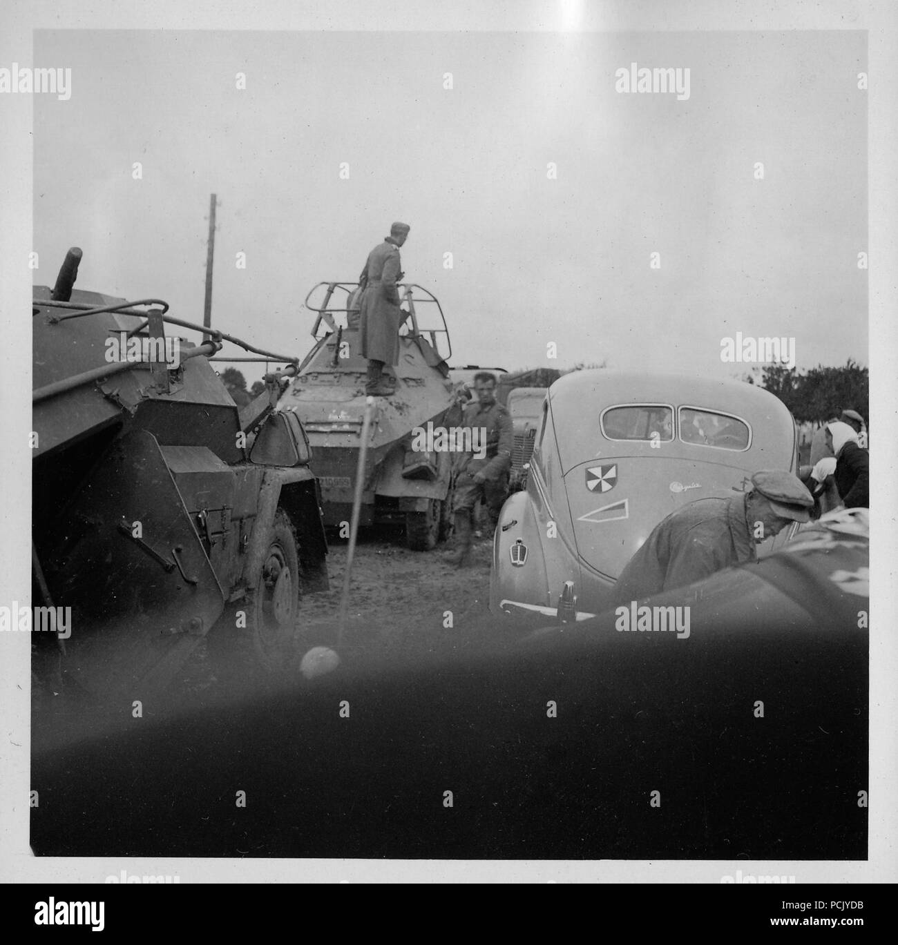 Image from a photo album relating to II. Gruppe, Jagdgeschwader 3: An Sd Kfz 263 Panzerfunkwagen (8 Rad) of Panzer Group Kleist, sits in front of an Sd Kfz 223 armoured car and a Chrysler staff car bearing the Gruppe badge of II./JG3, in a traffic jam, Russia summer 1941. Stock Photo