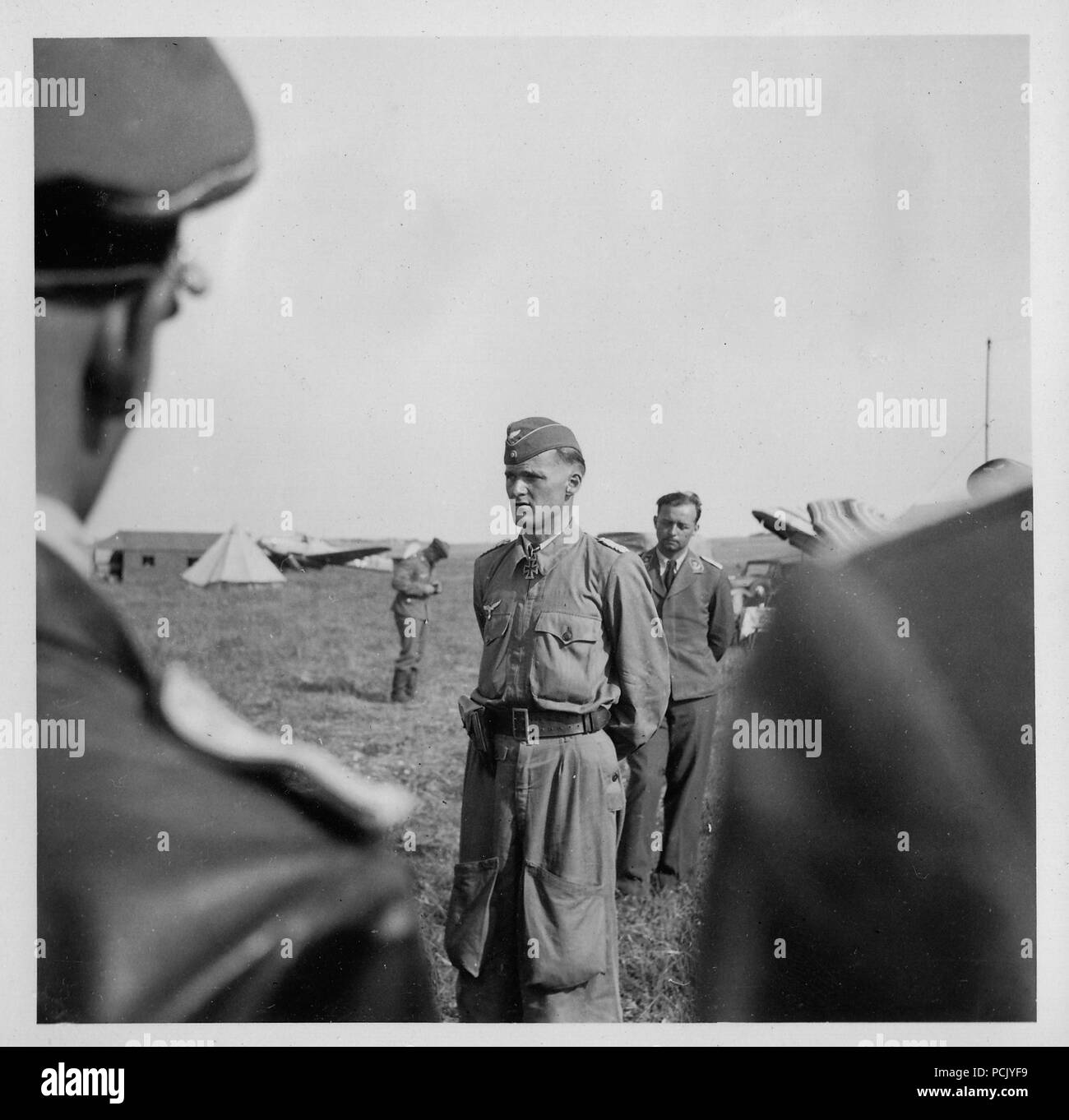 Image from a photo album relating to II. Gruppe, Jagdgeschwader 3: The Geschwaderkommodore of JG3 from 21st August 1940 to 11th August 1942, Major Günter Lützow (centre and facing the camera), talks to his officers early in Operation Barbarossa. Lützow wears the Knight's Cross of the Iron Cross that he was awarded on 18th September 1940. Stock Photo
