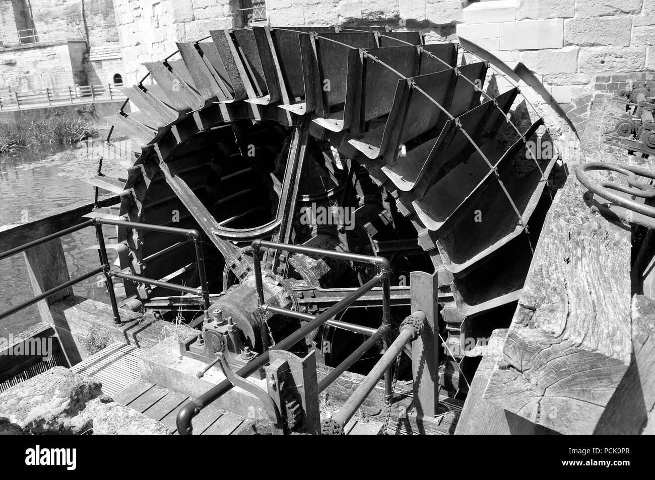 Black & White water wheel used for converting the energy of flowing into a useful form of power in Warwick castle Stock Photo