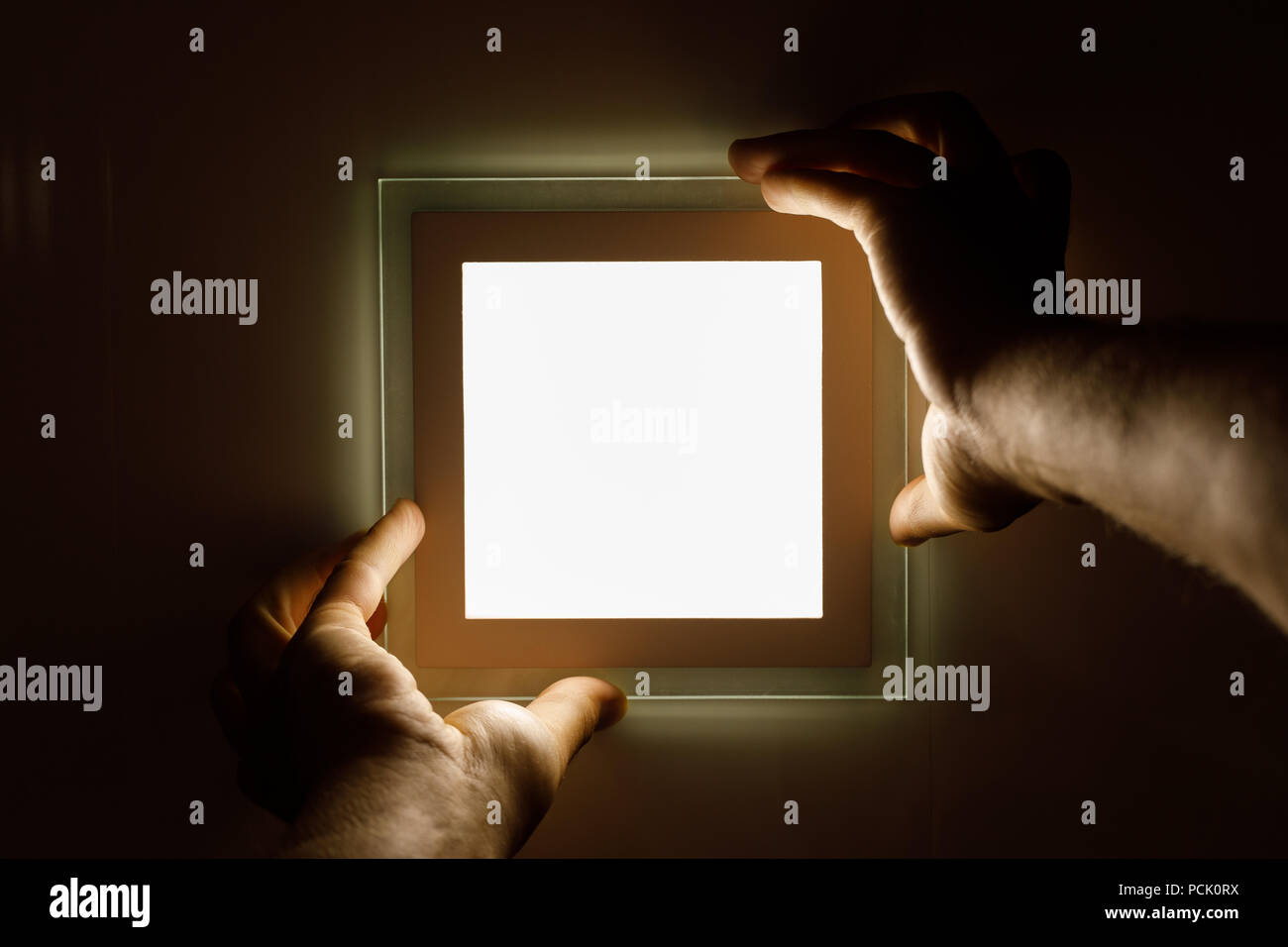 electrician installs an LED light Stock Photo