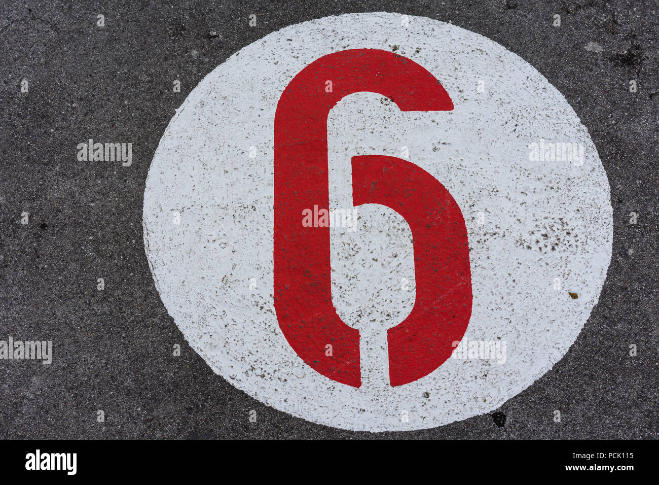 red number in white circle road sign direction on concrete Stock Photo