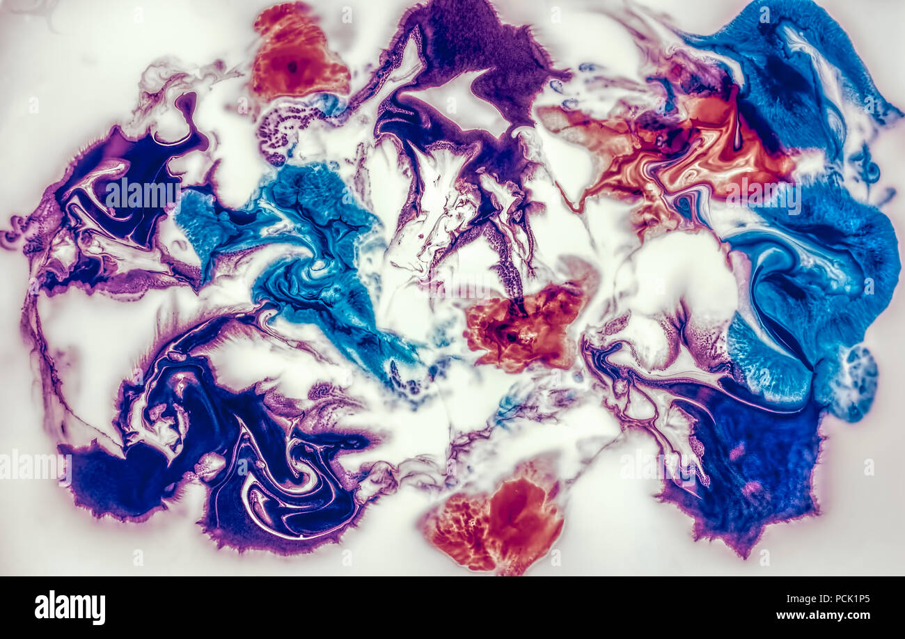 Coloring ink flowing and mixing in milk Stock Photo - Alamy