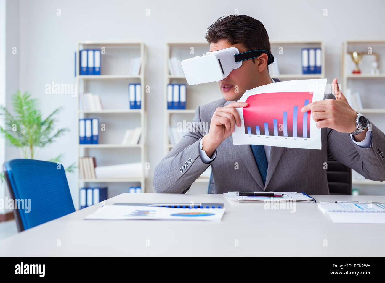 Businessman with virtual reality glasses in the office Stock Photo - Alamy