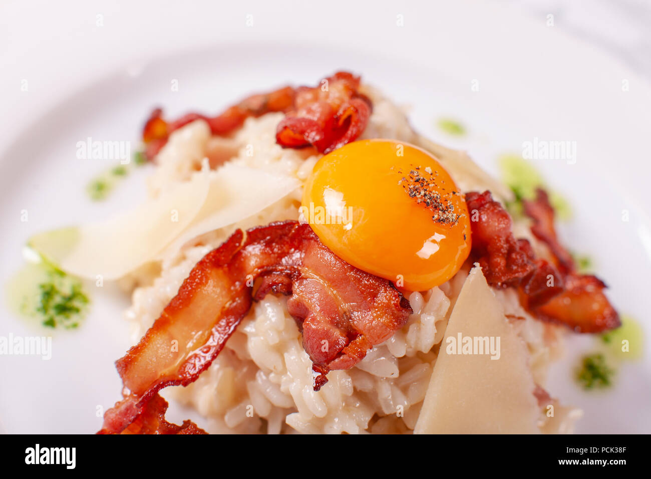 Italian Main Course. Risotto carbonara with egg yolk, Parmesan cheese
