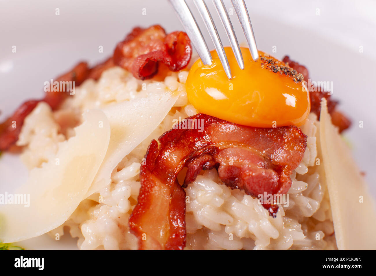Italian Main Course. Risotto carbonara with egg yolk, Parmesan cheese