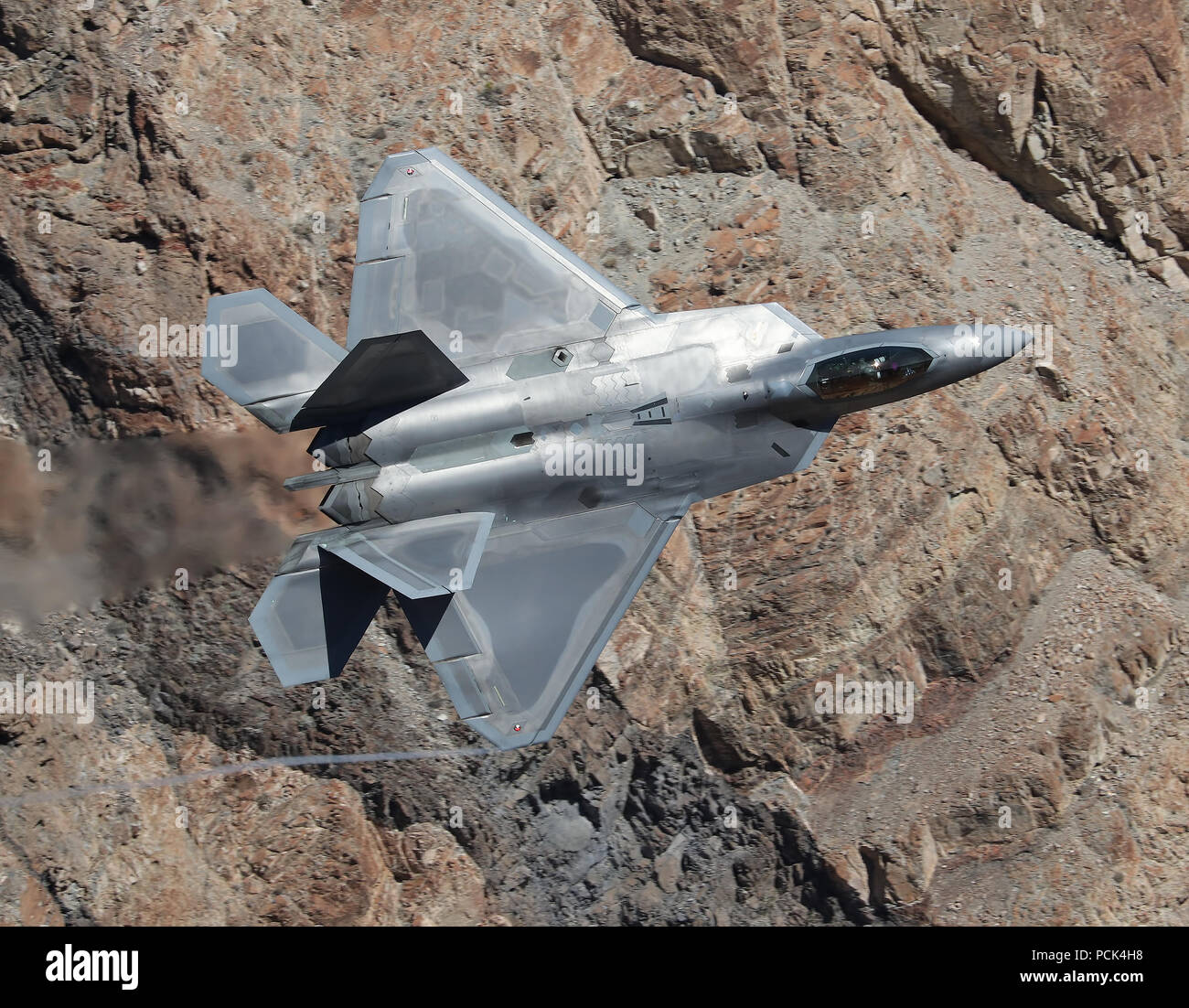 USAF F-22A Raptor is flying though Star Wars Canyon, California. This fighter belongs to 422nd TES, 53 WG, Nellis AFB Stock Photo