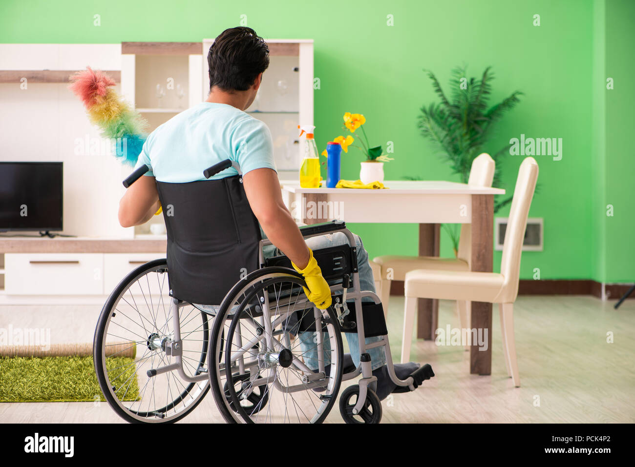 Disabled man on wheelchair cleaning house Stock Photo Alamy