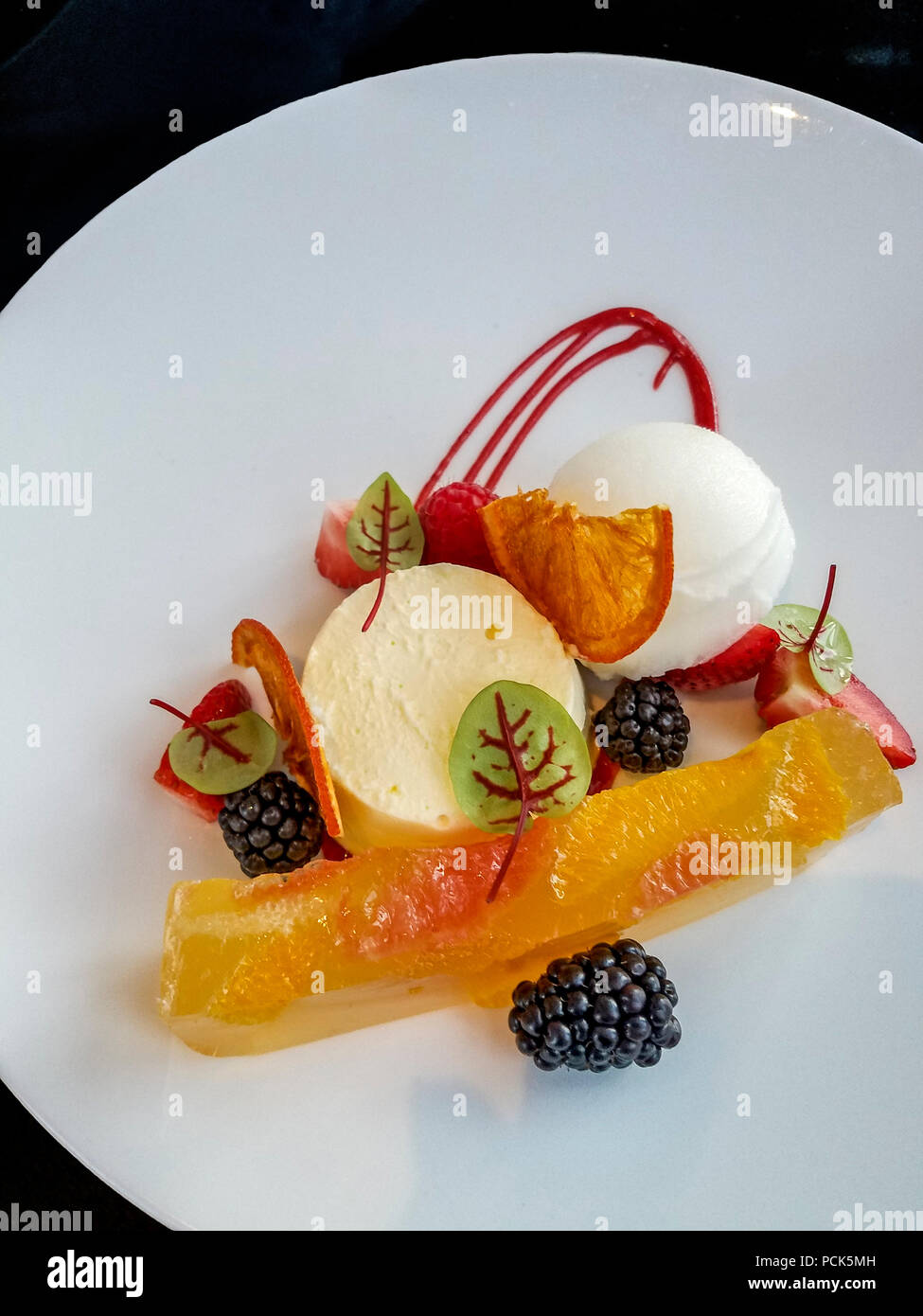 Yuzu Semi Freddo.. a citrus gelatin along with dehydrated orange and tangy sorbet. Stock Photo