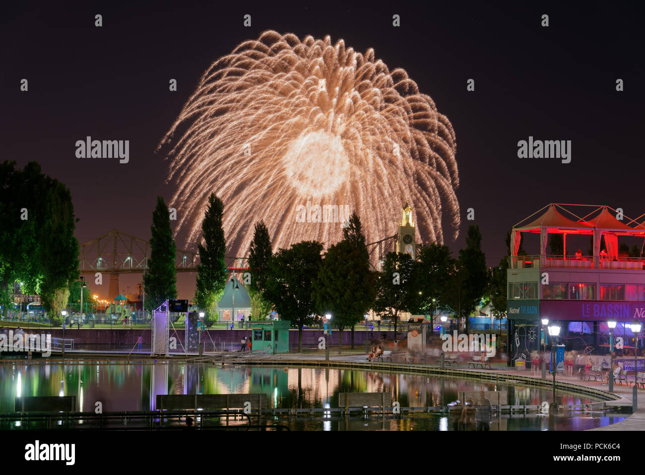 The Montreal International Fireworks Competition with the Montreal Harbour Bridge and Old Port Clock Tower and Bassin Bonsecours Stock Photo