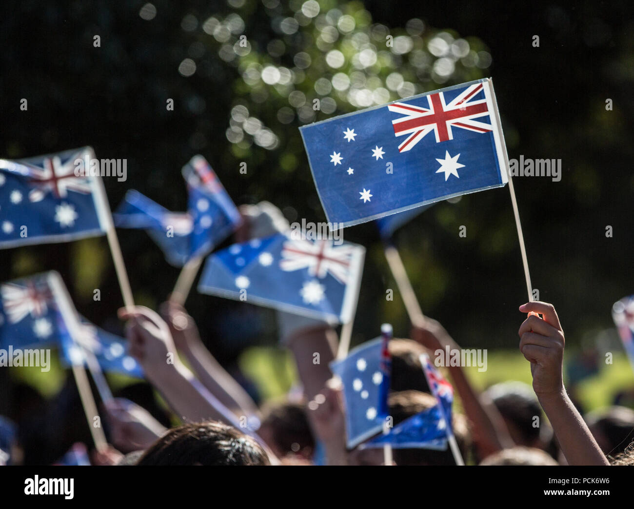 Australian flags being waved by school children Stock Photo