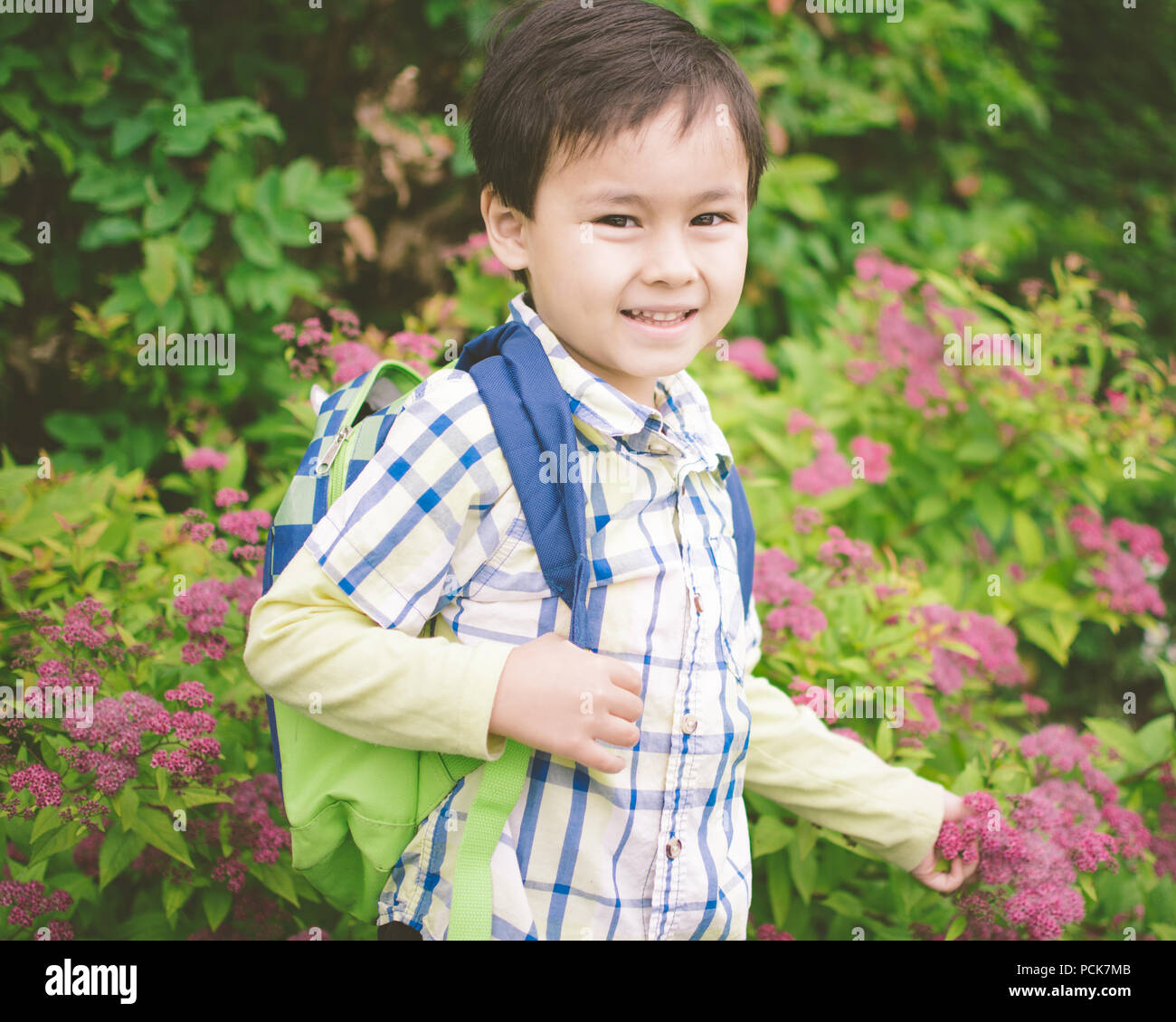 Young Boy Holding A Backpack Is Excited To Go Back To School Young Boy Holding A Backpack Is Excited To Go Back To School Stock Photo