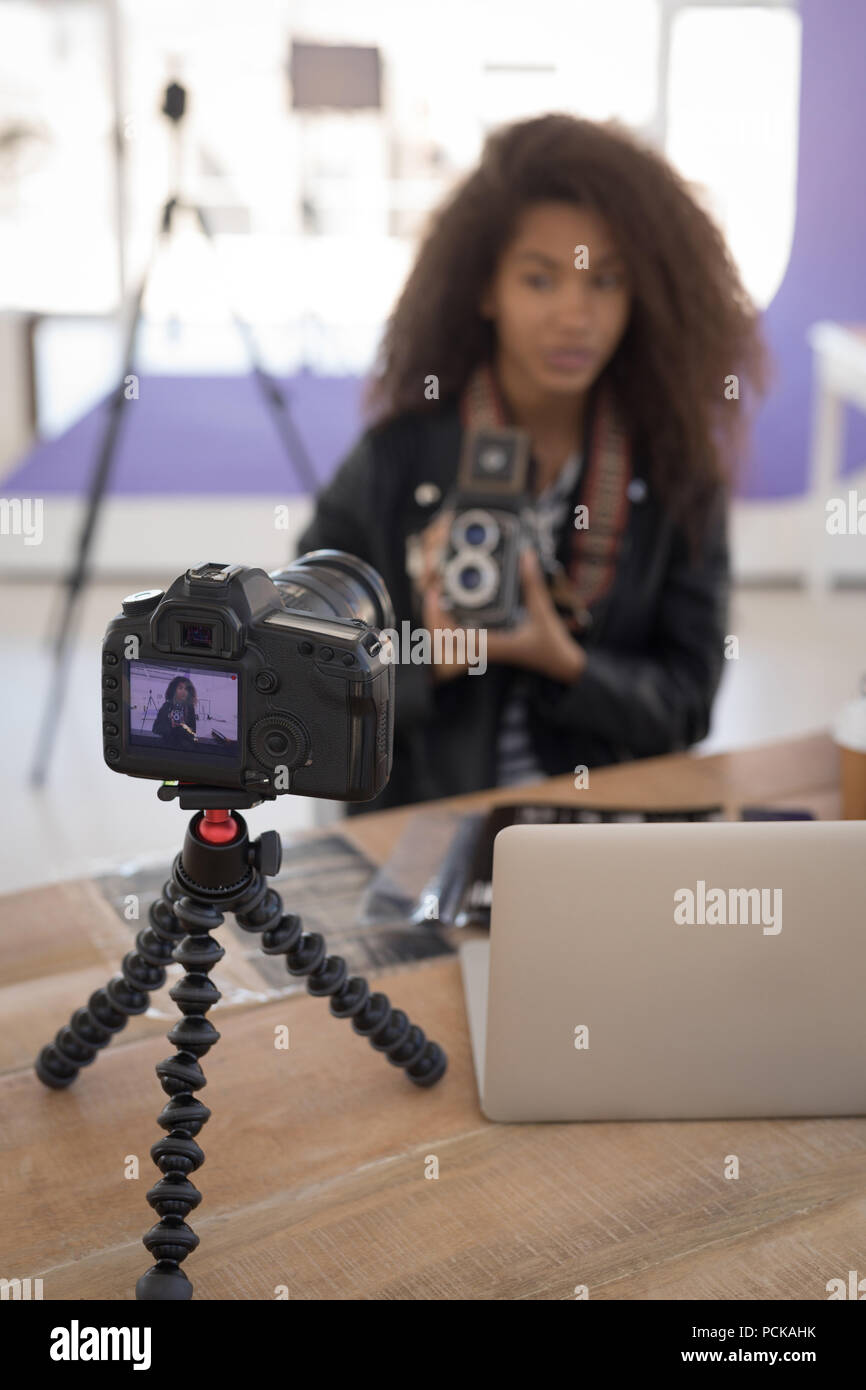 Pretty photographer working at laptop Stock Photo
