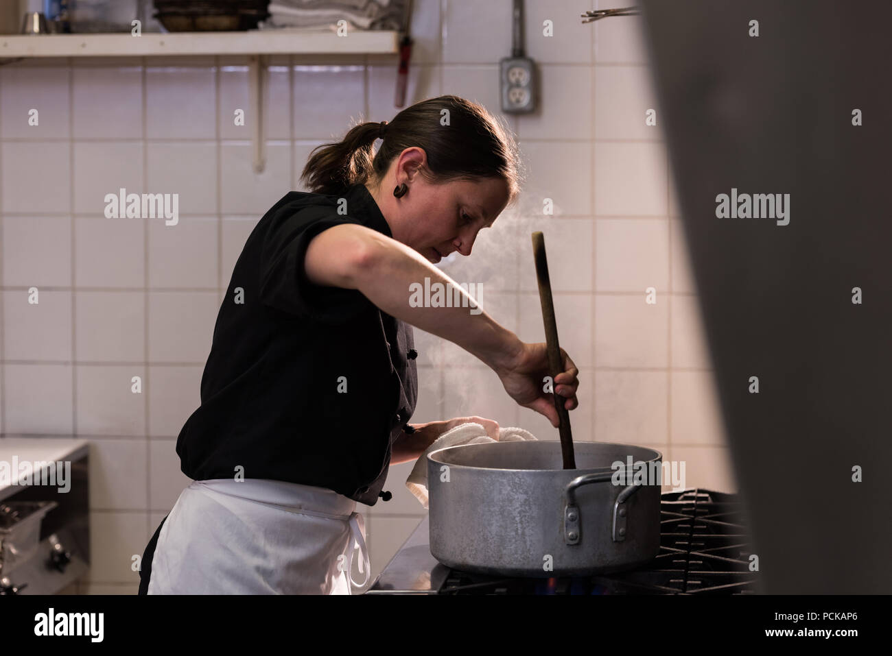 Woman stirring giant cooking pot hi-res stock photography and images - Alamy