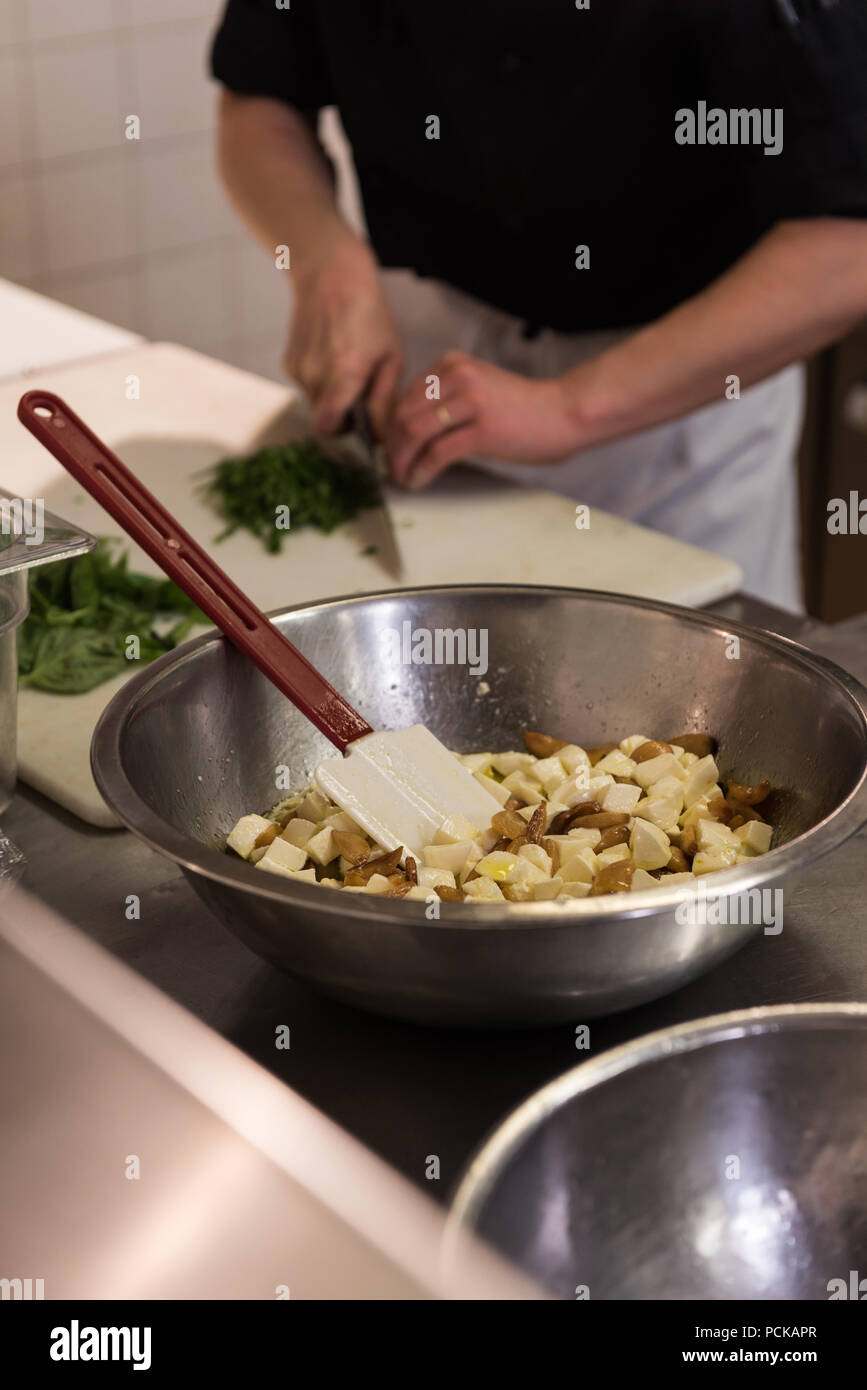 Chef preparing the ingredients in commercial kitchen Stock Photo Alamy