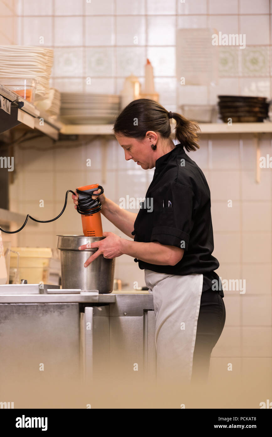 Chef blending with hand blender Stock Photo