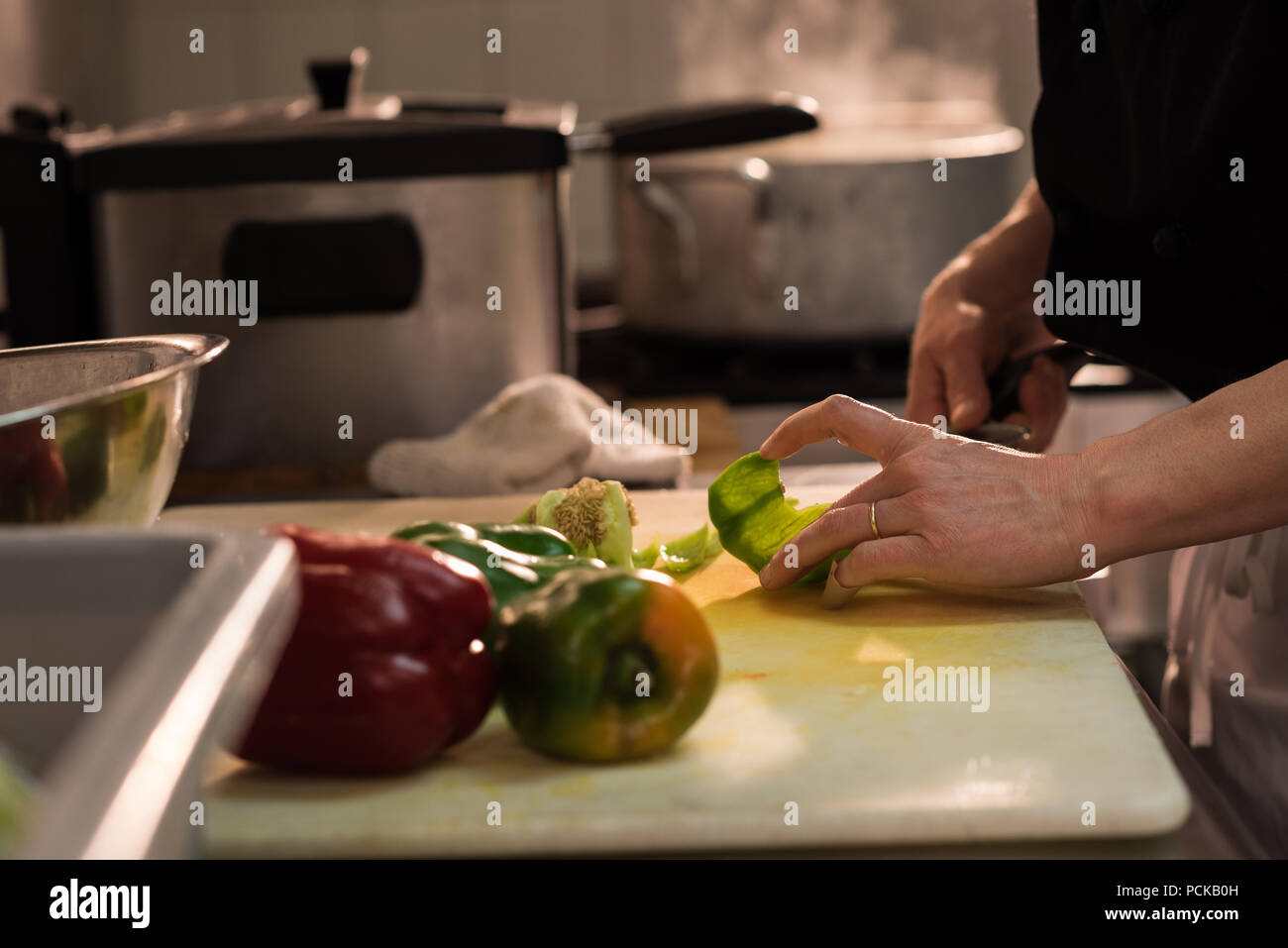 Chef chopping vegetable in the commercial kitchen Stock Photo