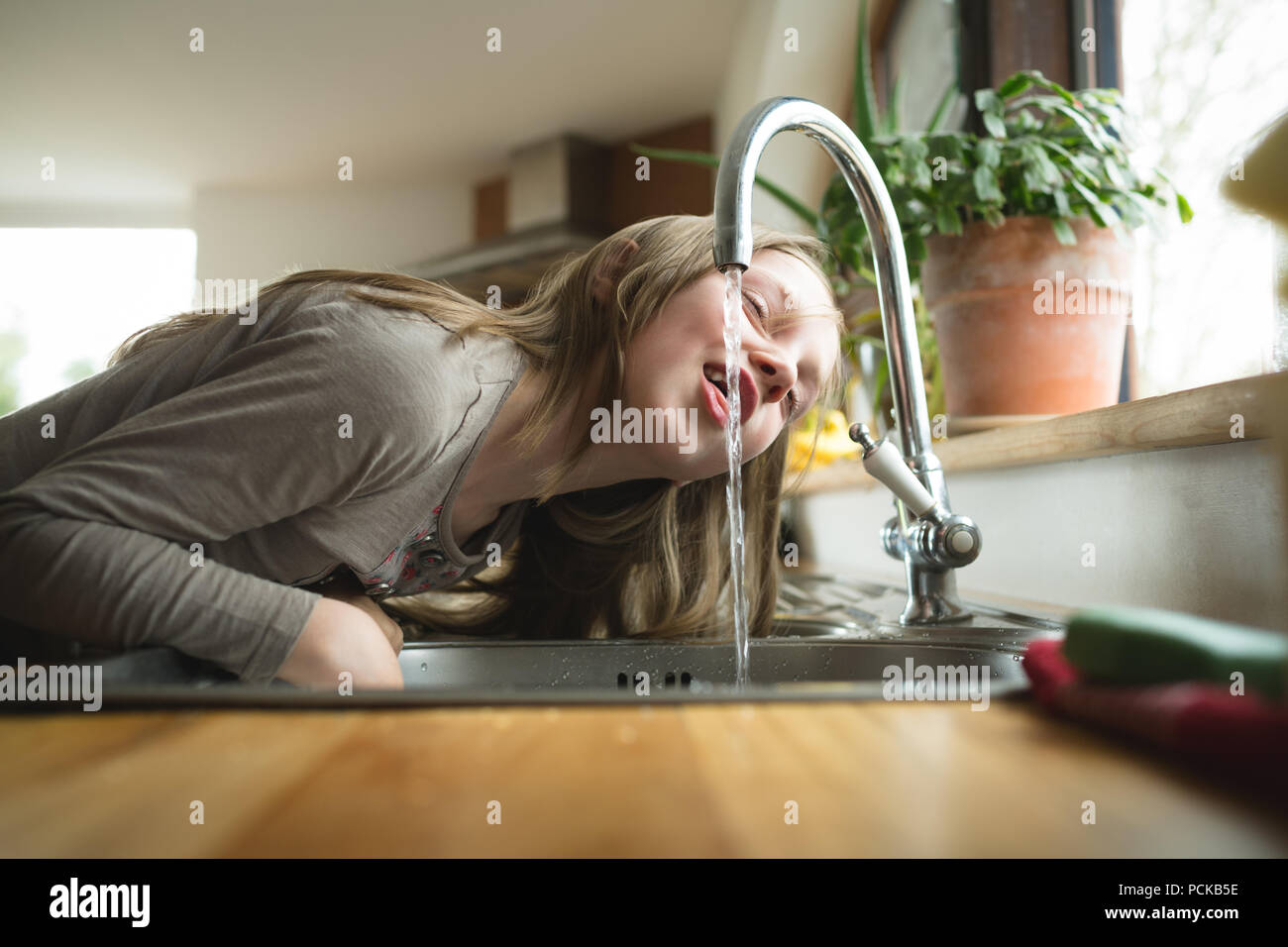 Girl drinking water from tap hires stock photography and images Alamy