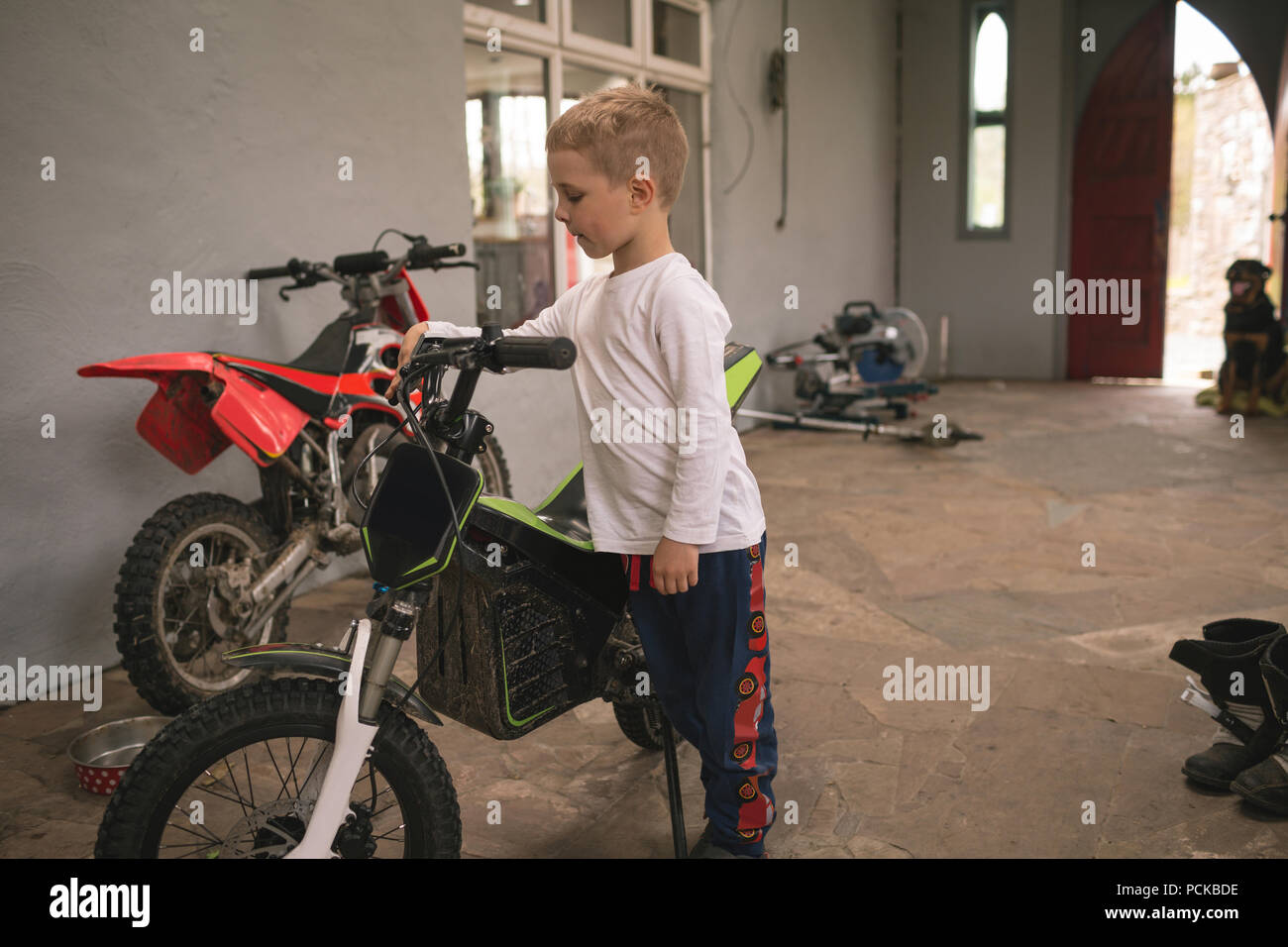 Little kid standing with bike Stock Photo