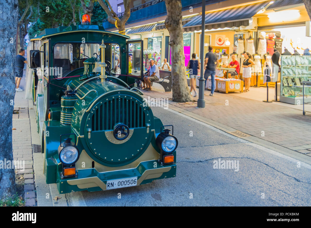 Locomotive of a small tourist train in the streets of Igea Marina near ...