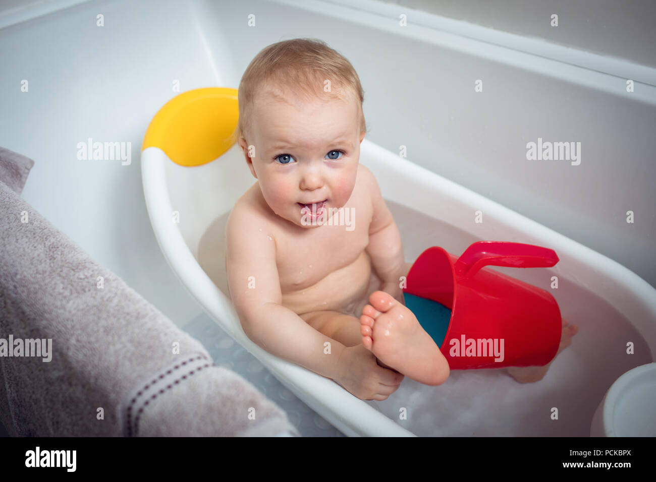 Baby girl taking bath in bathtub Stock Photo Alamy