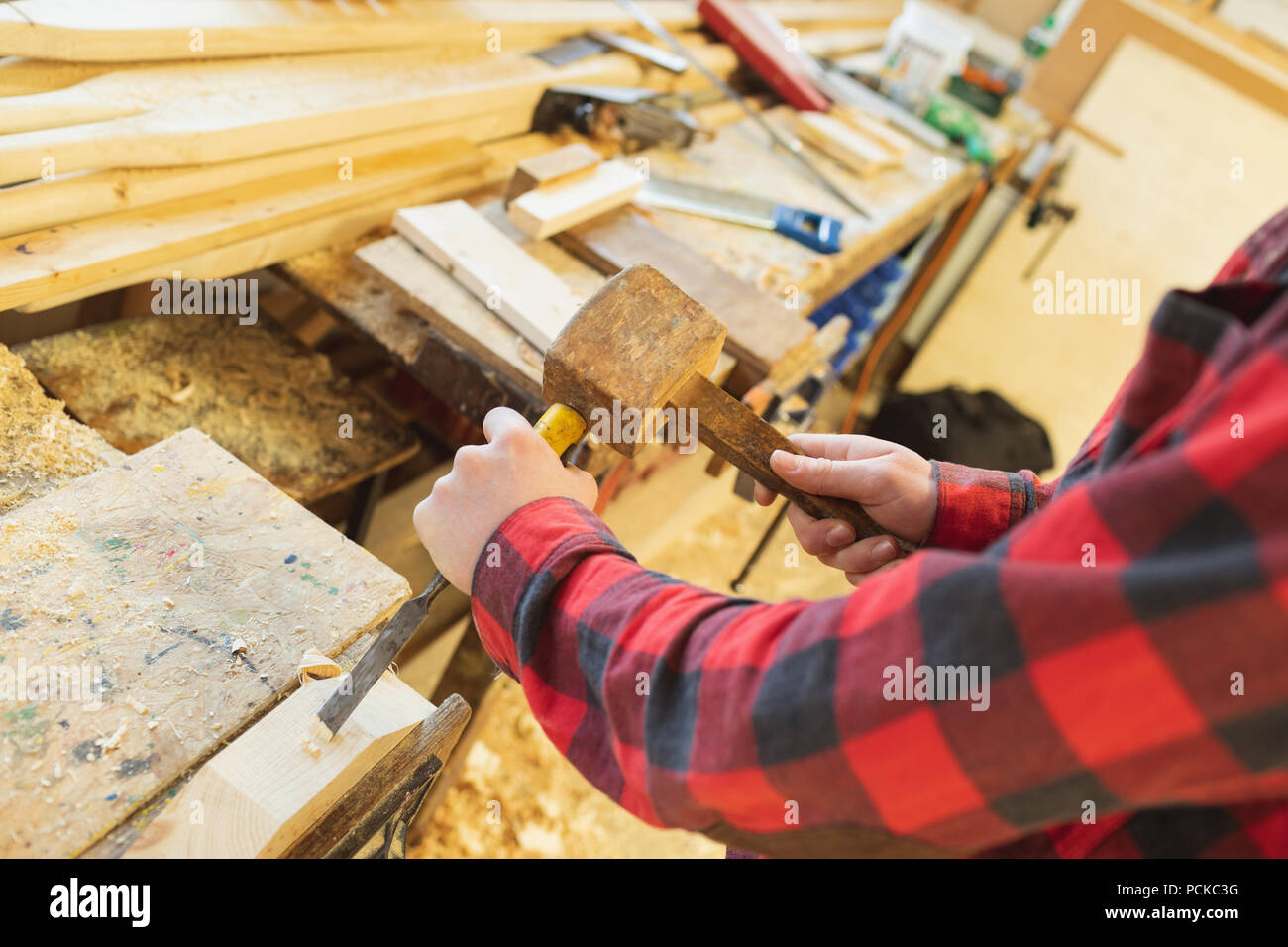Male carpenter using chisel with hammer Stock Photo Alamy
