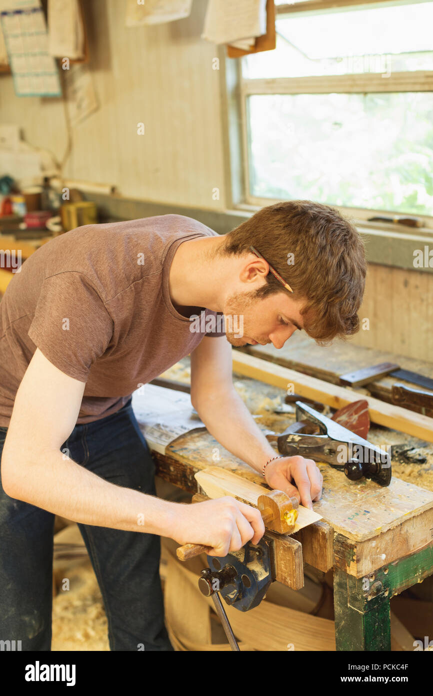 Male carpenter using marking gauge in workshop Stock Photo