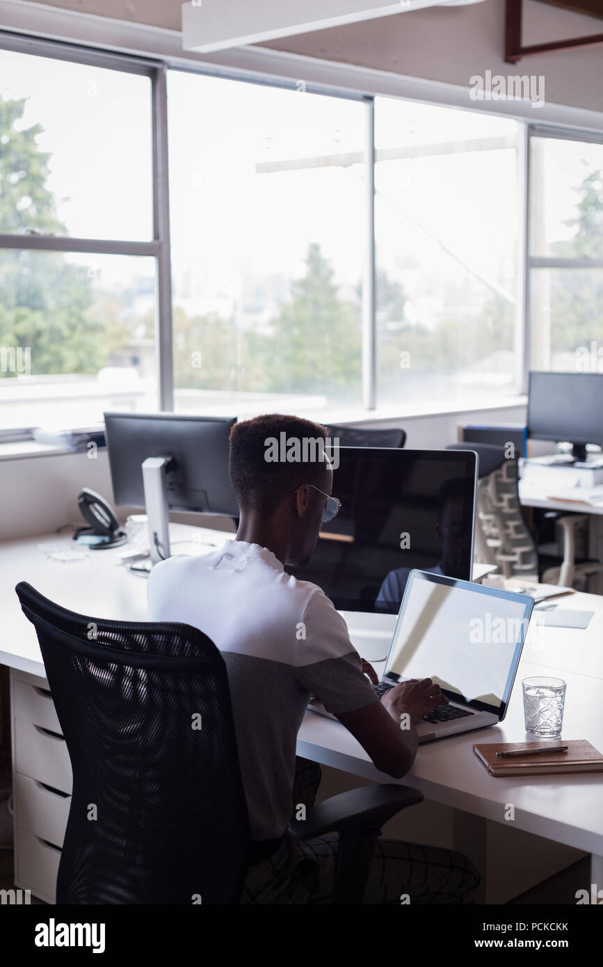 Casual businessman working on laptop Stock Photo