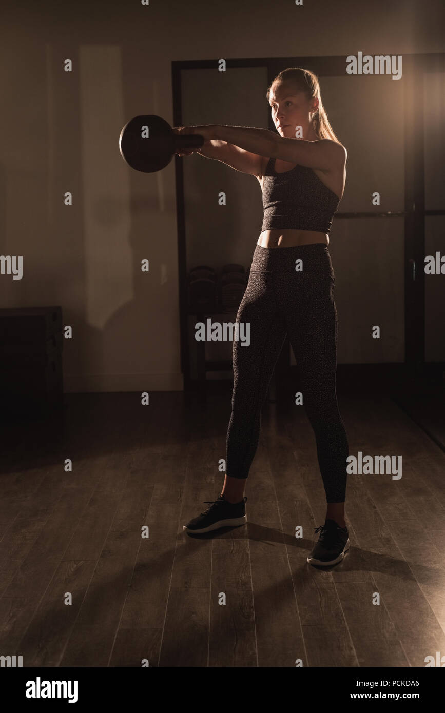 Woman doing exercises with kettlebell Stock Photo