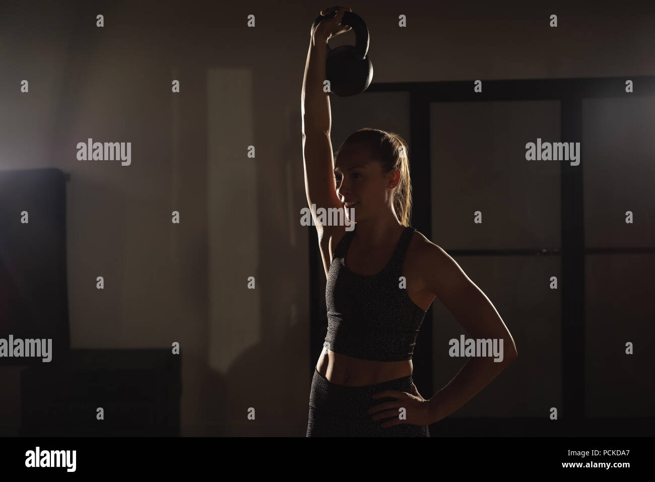 Woman doing exercises with kettlebell Stock Photo