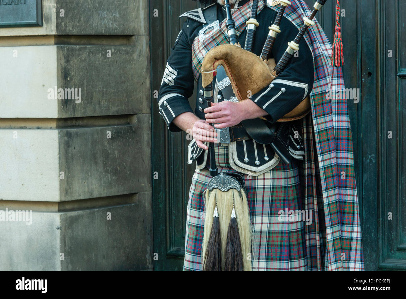 bagpipe and guitar players live performing over the Edinburgh street