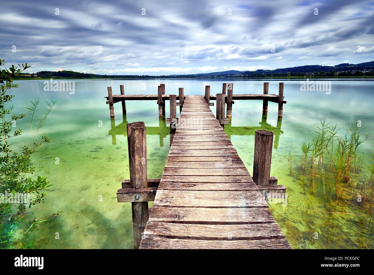 Wooden pier at Pfäffikersee, cloudy sky, Pfäffikon, Canton of Zurich, Switzerland Stock Photo