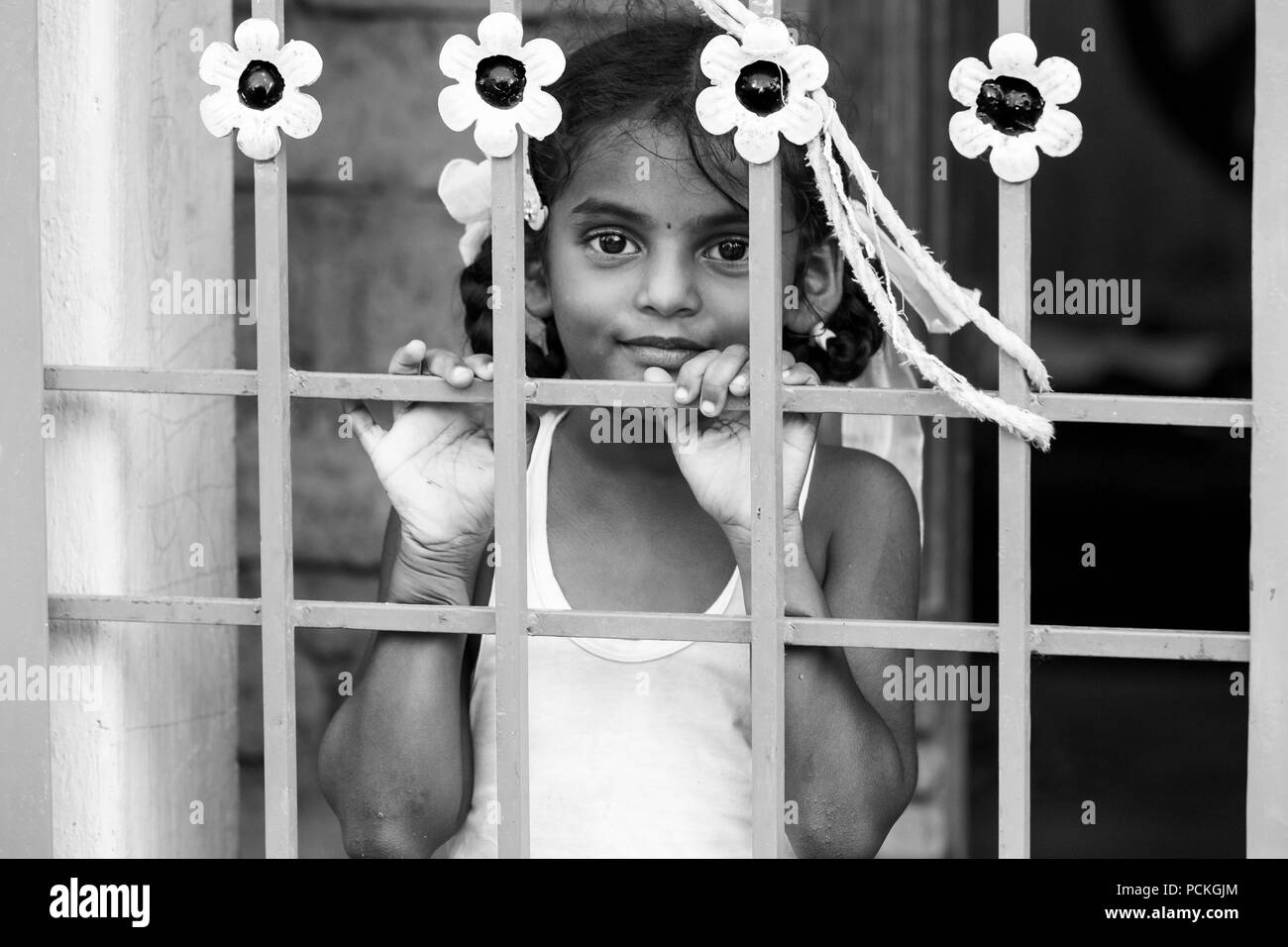 PONDICHERY, PUDUCHERRY, TAMIL NADU, INDIA - March circa, 2018. Closeup portrait of unidentified shy timid young pretty Indian girl child looking away  Stock Photo