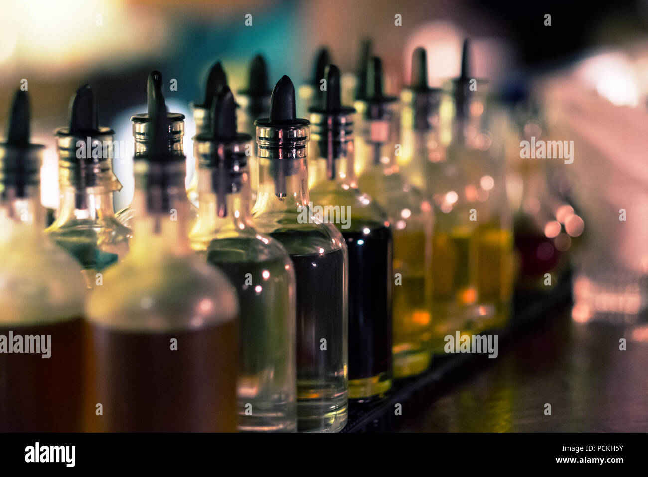 Bottles with syrups for mixing cocktails on bar counter. Alcohol drinks