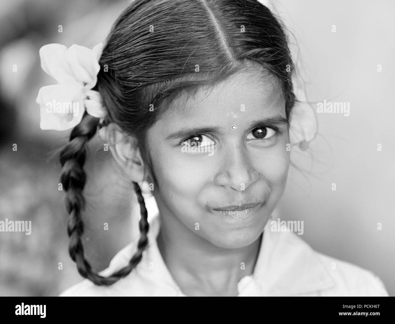 PONDICHERY, PUDUCHERRY, TAMIL NADU, INDIA - SEPTEMBER Circa, 2017. An unidentified poor girl in a small village, outdoor, looking at the camera. Black Stock Photo