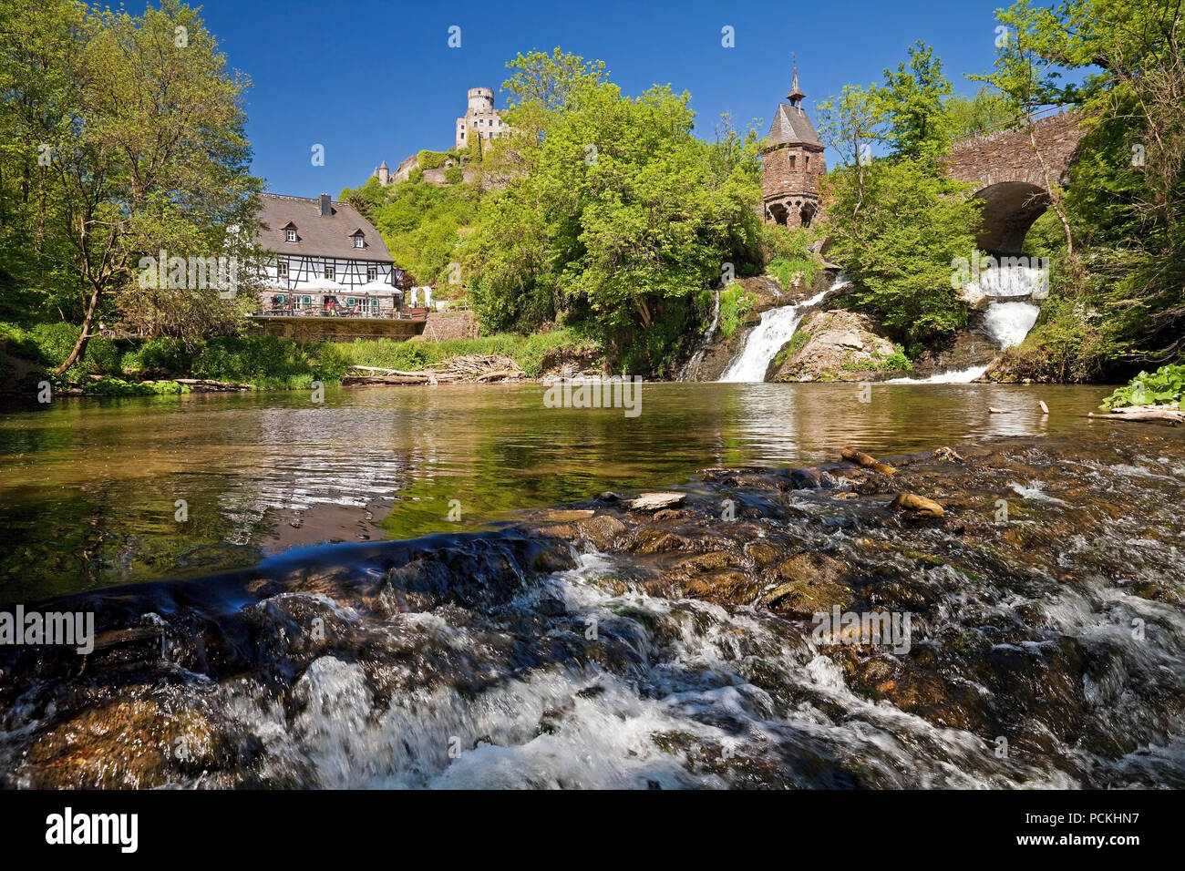 Pyrmonter mill at the waterfall of Elzbach with the castle Pyrmont in the back, Roes, Eifel, North Rhine-Westphalia, Germany Stock Photo