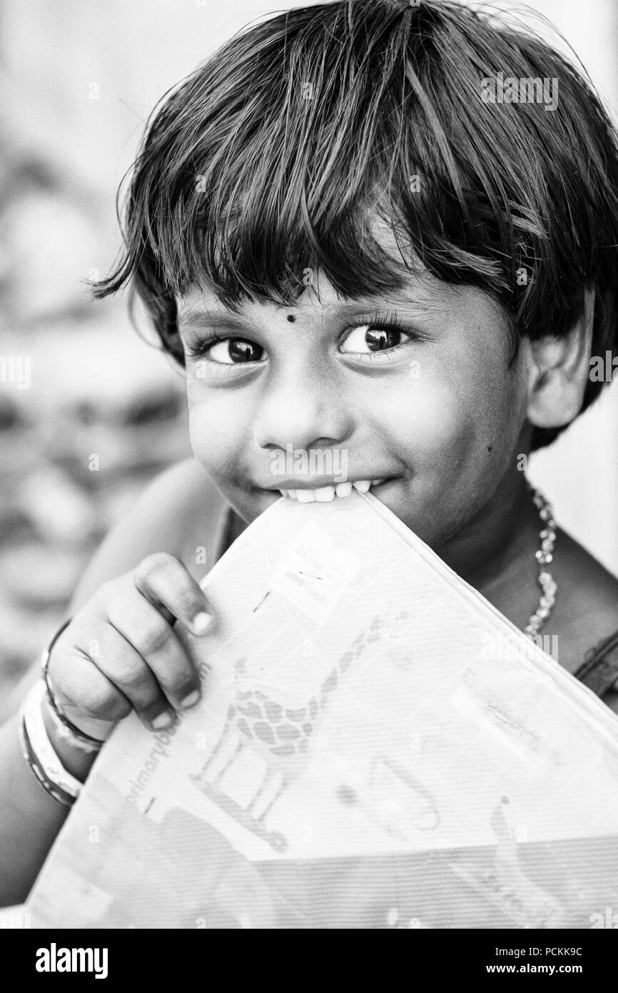 PONDICHERY, PUDUCHERRY, TAMIL NADU, INDIA - SEPTEMBER CIRCA, 2017. Portrait of unidentified Indian poor kid child girl is smiling outdoor in the stree Stock Photo
