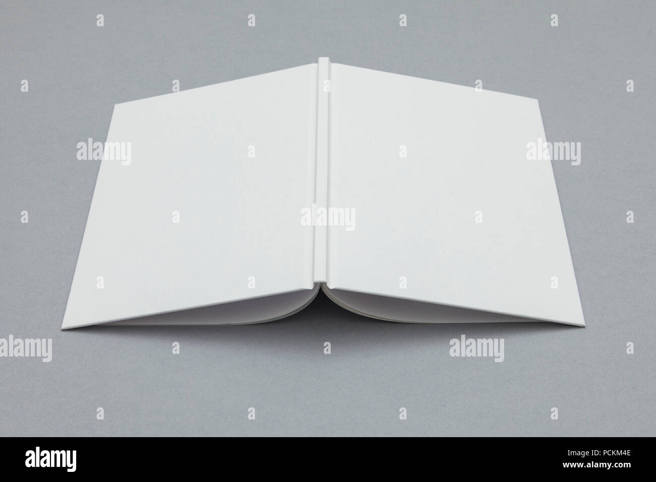 Hardback book mockup. White book on a grey background Stock Photo