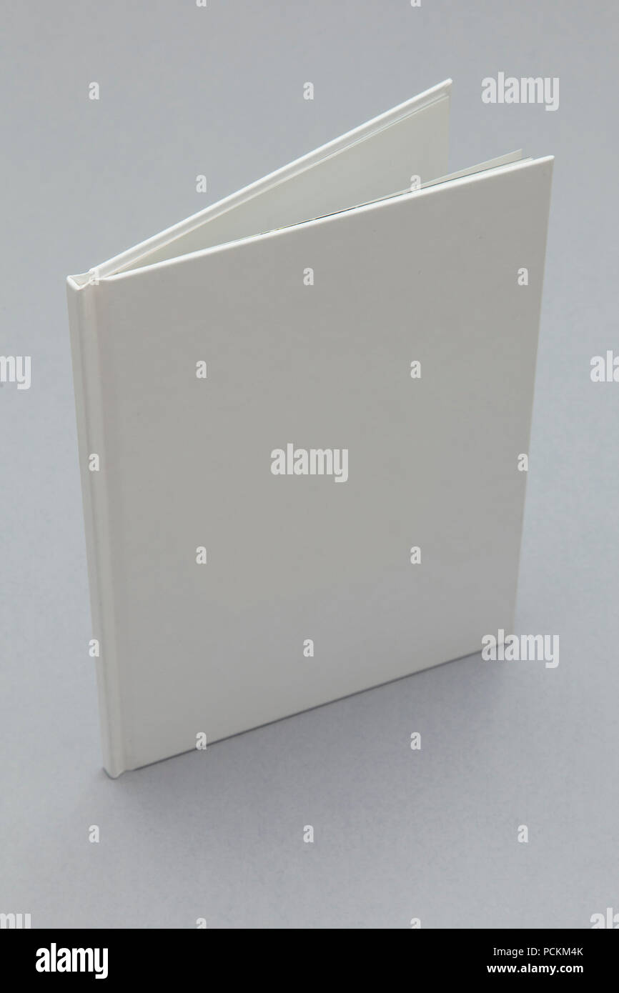 Hardback book mockup. White book on a grey background Stock Photo