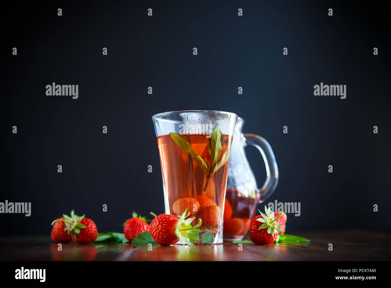 Sweet compote of ripe red strawberries in a glass decanter Stock Photo