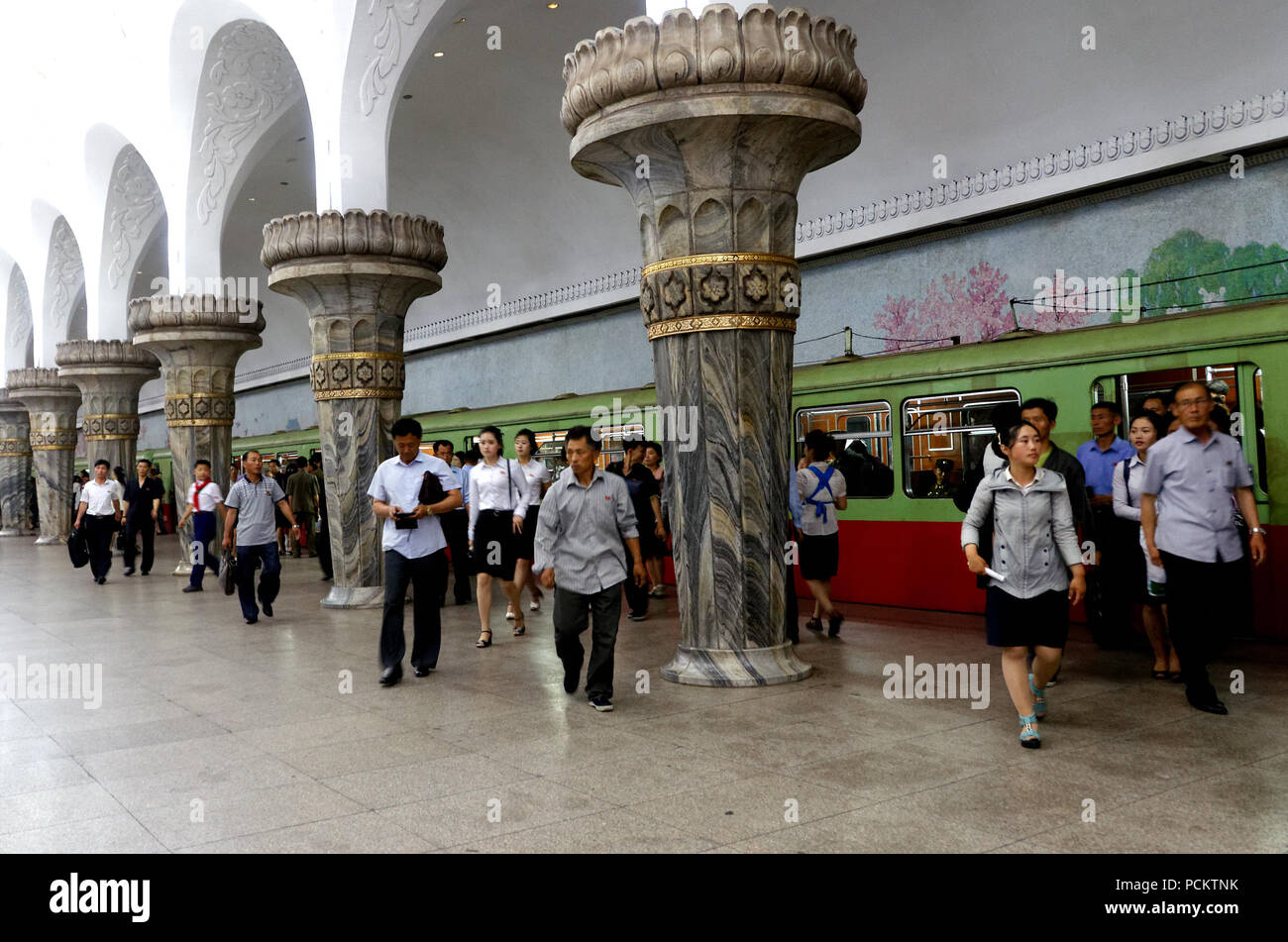 Commuters getting off an underground train At the Glory station on the Pyongyang Metro, North Korea Stock Photo