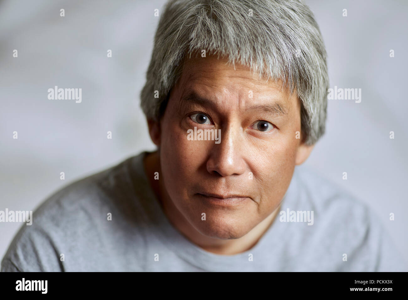 Portrait Of A Chinese Man With Gray Hair Brown Eyes And