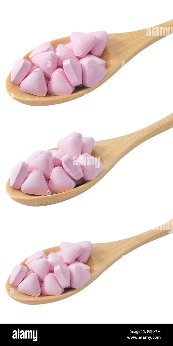 Healthcare Concept, Wooden Spoons Full with Vitamins Pills isolated on White Background. Stock Photo