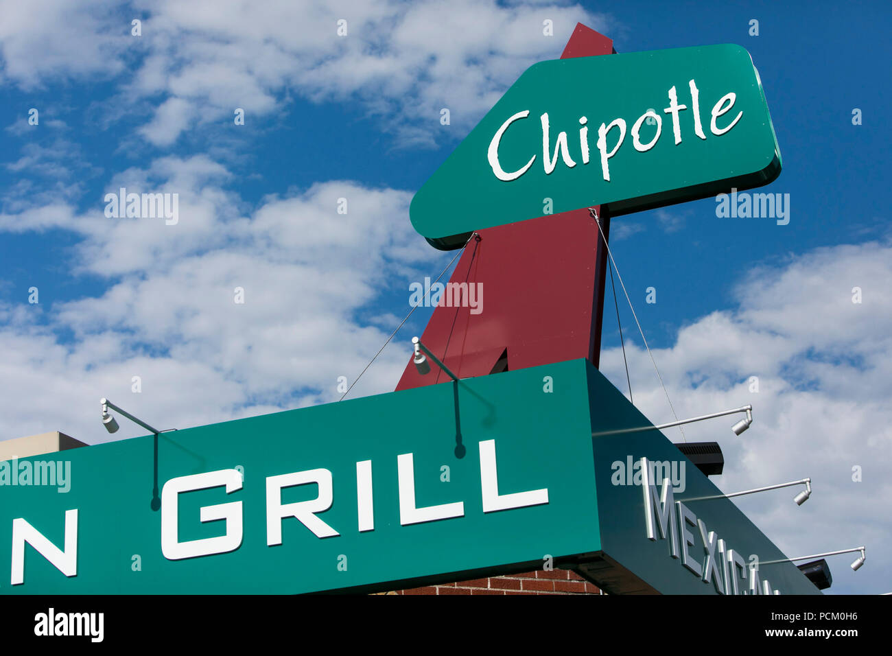 A logo sign outside of the first Chipotle fast casual restaurant
