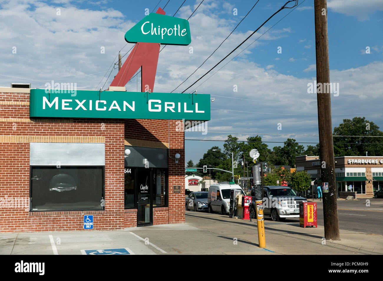 A logo sign outside of the first Chipotle fast casual restaurant