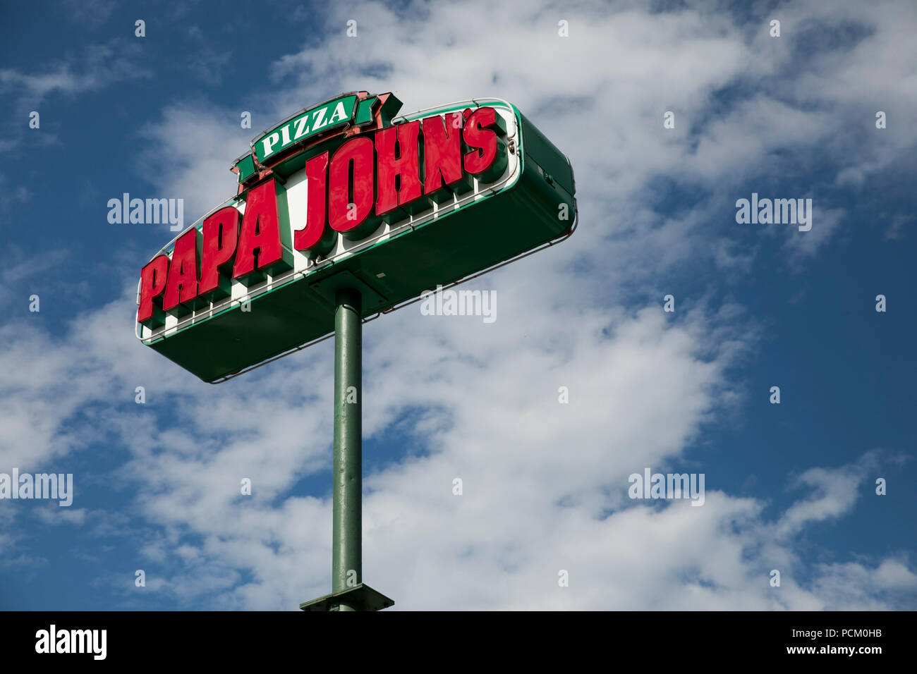 A logo sign outside of a Papa John's Pizza franchise location in Denver