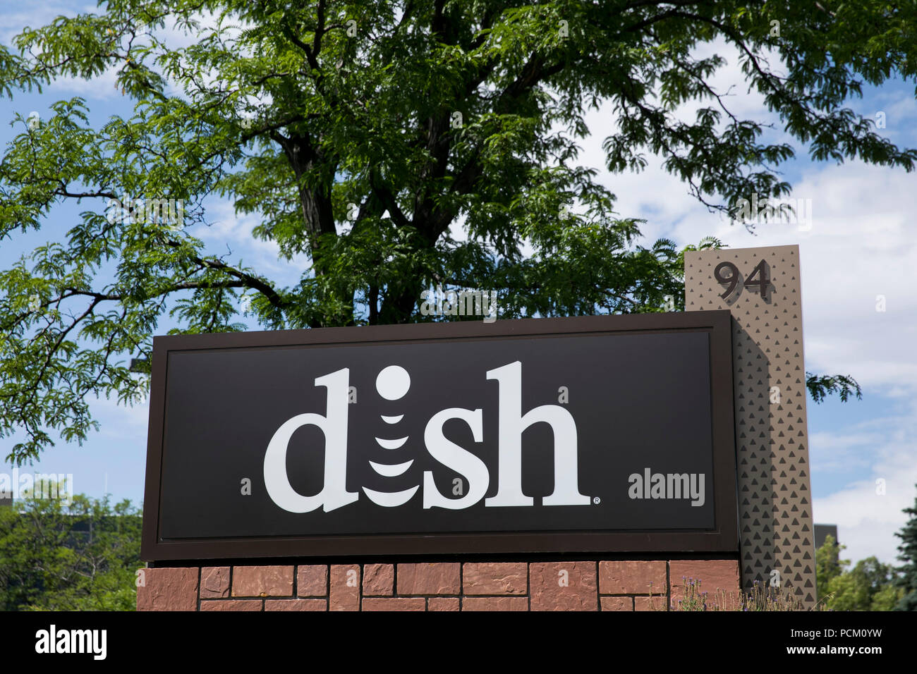 A logo sign outside of a facility occupied by the Dish Network