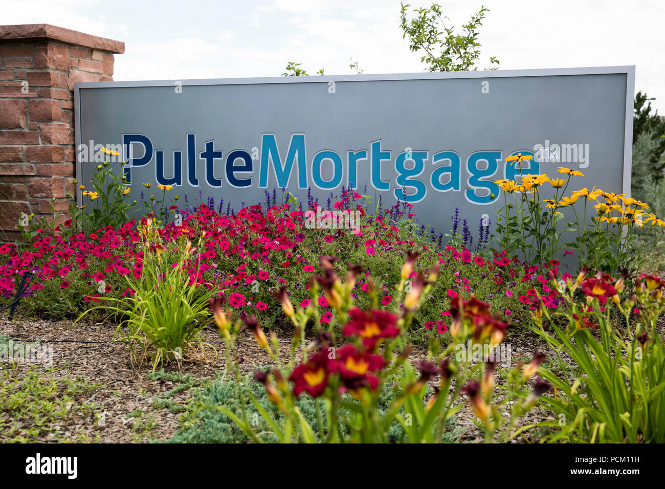 A logo sign outside of a facility occupied by Pulte Mortgage, a