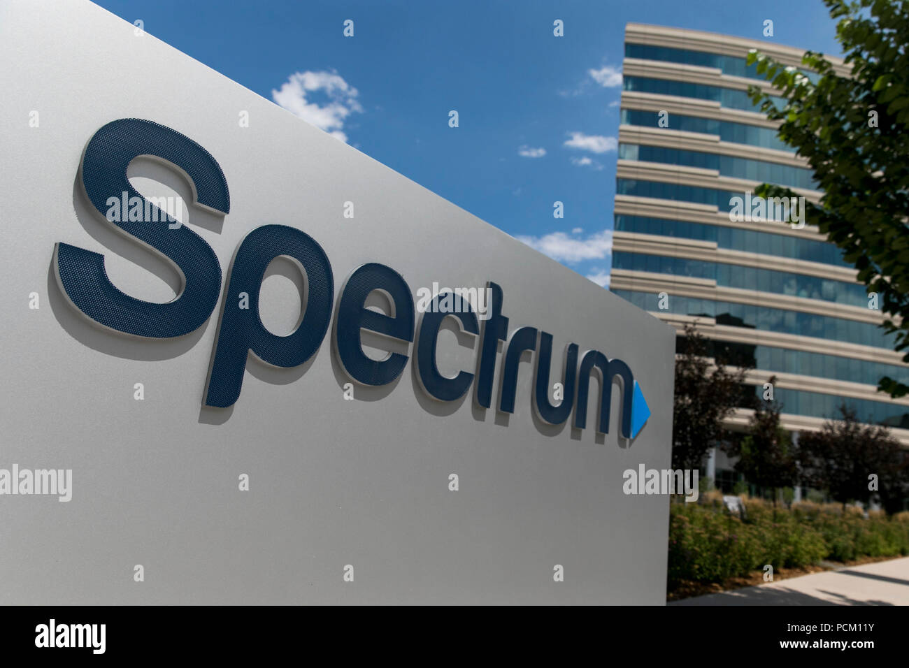 A logo sign outside of a facility occupied by cable television and internet provider Spectrum in Greenwood Village, Colorado, on July 22, 2018. Stock Photo