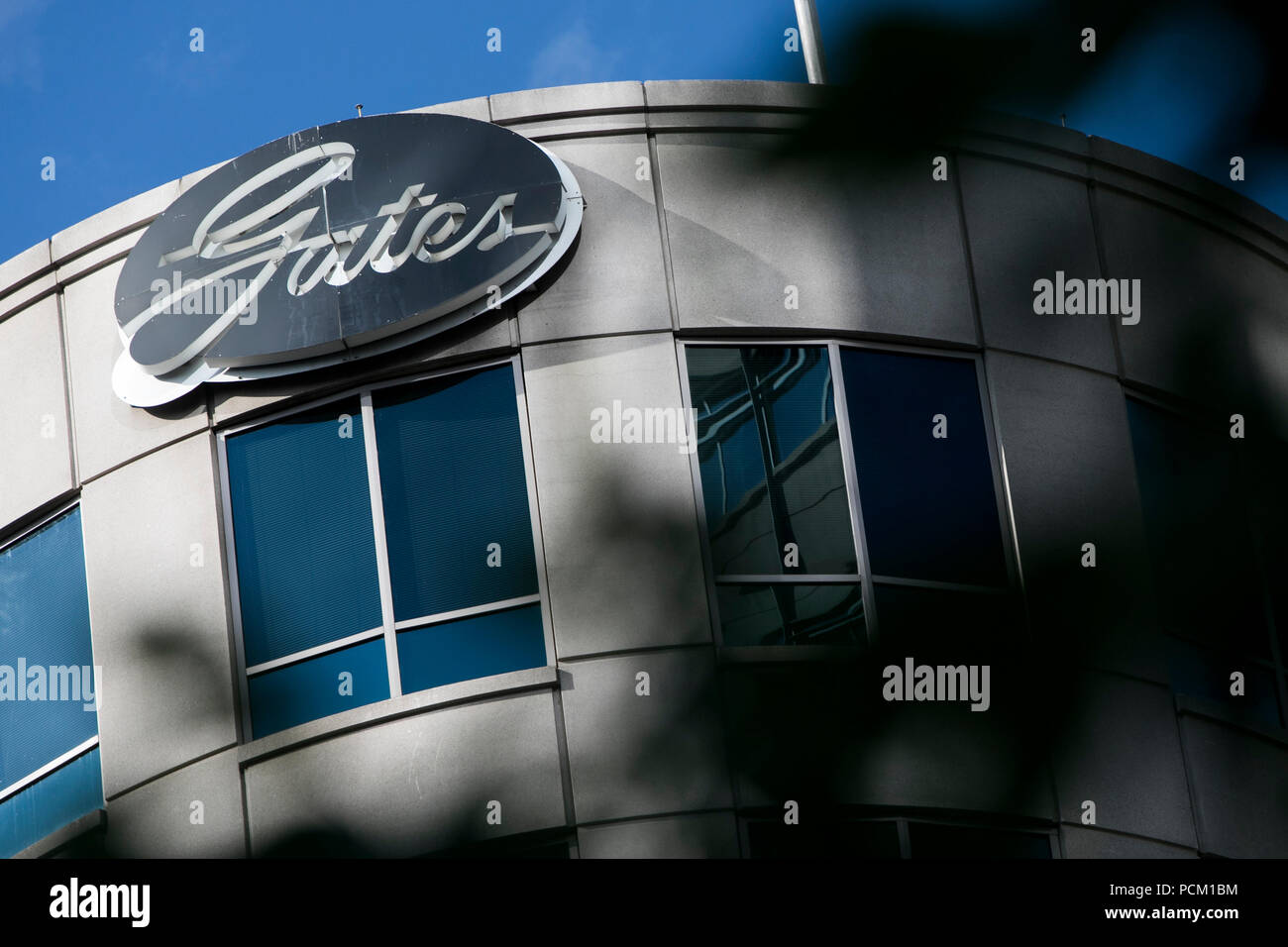 A logo sign outside of the headquarters of the Gates Corporation in