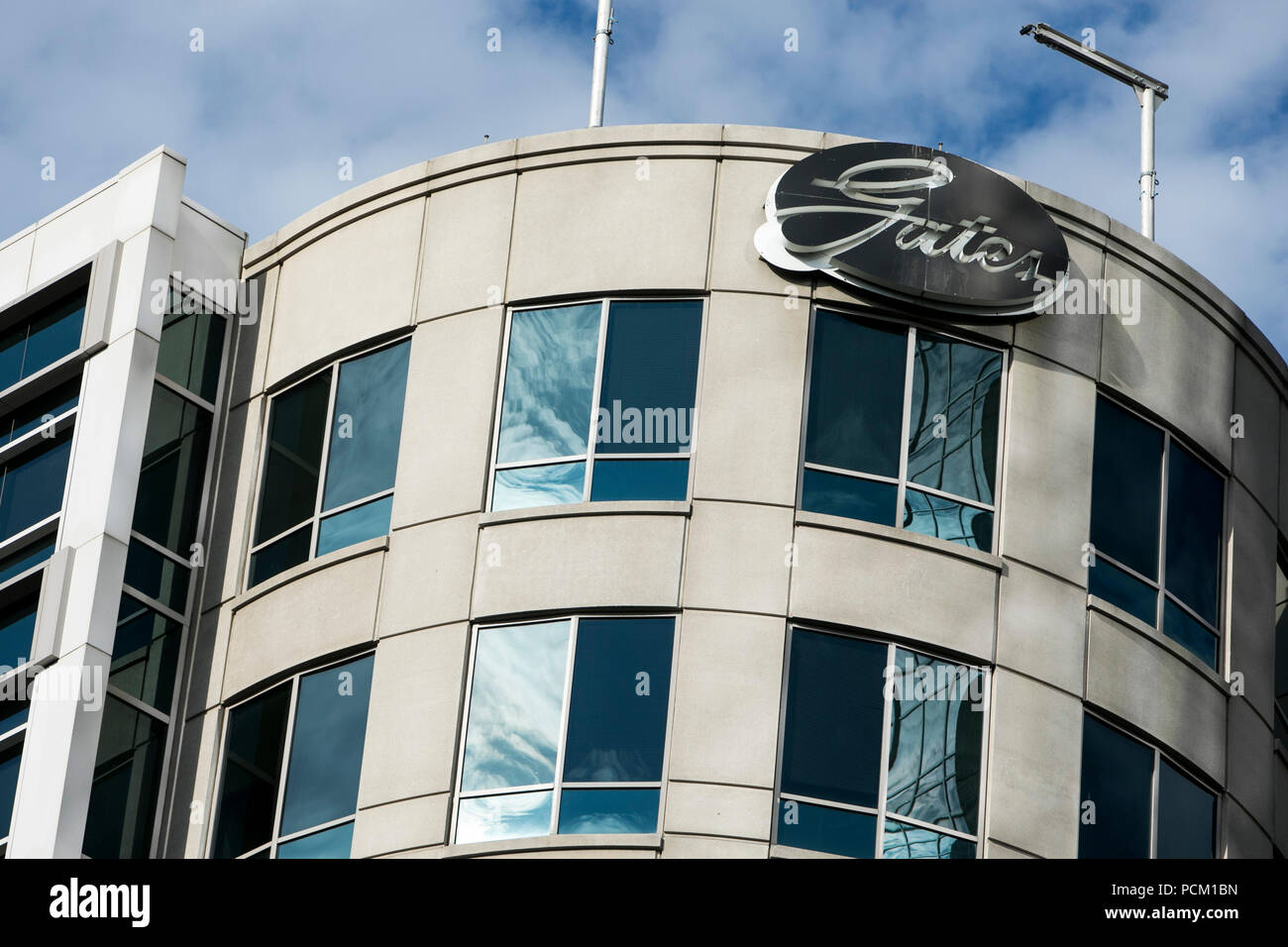 A logo sign outside of the headquarters of the Gates Corporation in